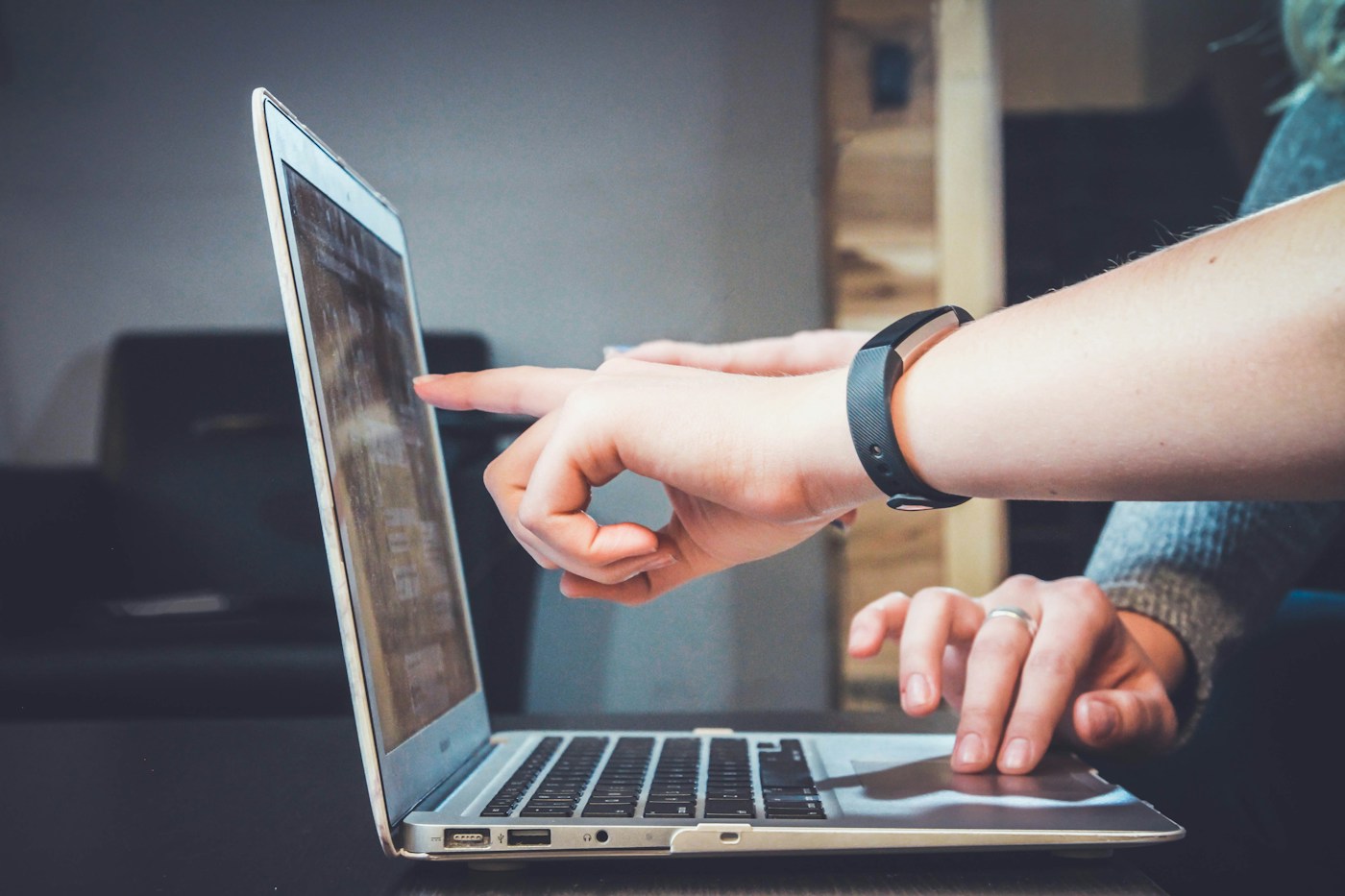 Illustrative team collaborating around a laptop for a website project